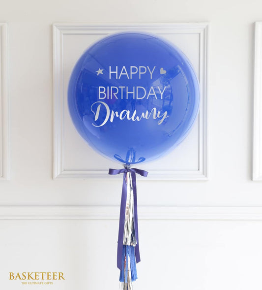 Blue Happy Birthday balloon with purple ribbon and metallic streamers, ready-to-gift celebration decoration