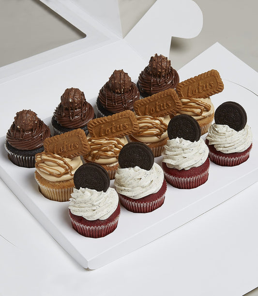 Dozen gourmet cupcakes with chocolate, Lotus biscuit, and red velvet Oreo toppings in gift box