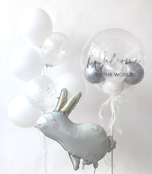 Welcome Baby Bunny balloon bouquet with white latex, silver glitter, and foil rabbit for newborn celebrations