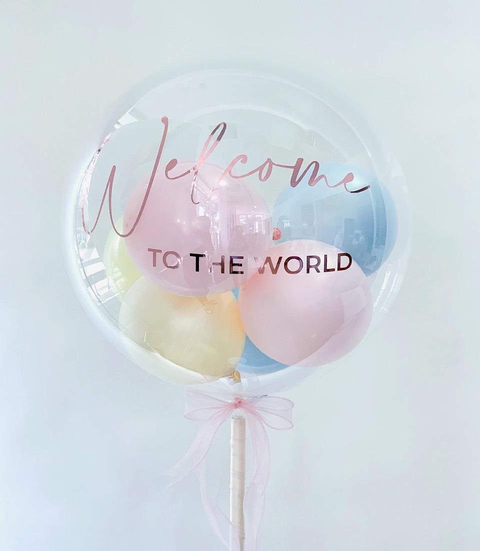 Welcome to the World pastel balloon gift with rose gold text and pink ribbon