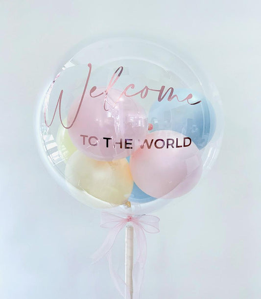 Welcome to the World pastel balloon gift with rose gold text and pink ribbon