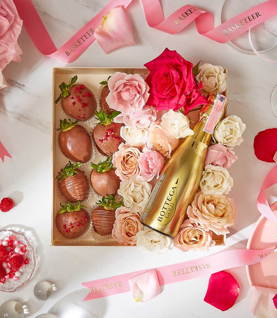 Luxury Valentine gift box with chocolate-covered strawberries, fresh roses, and Bottega Gold sparkling wine