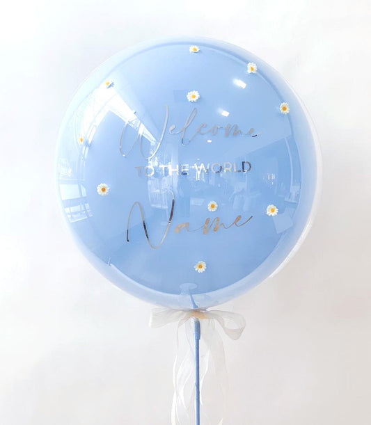 Light blue bubble balloon with white daisy stickers and silver "Welcome to the world" text, personalisable name space, white