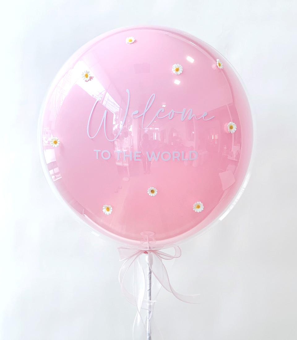 Pink welcome baby bubble balloon with daisy flowers and white ribbon bow