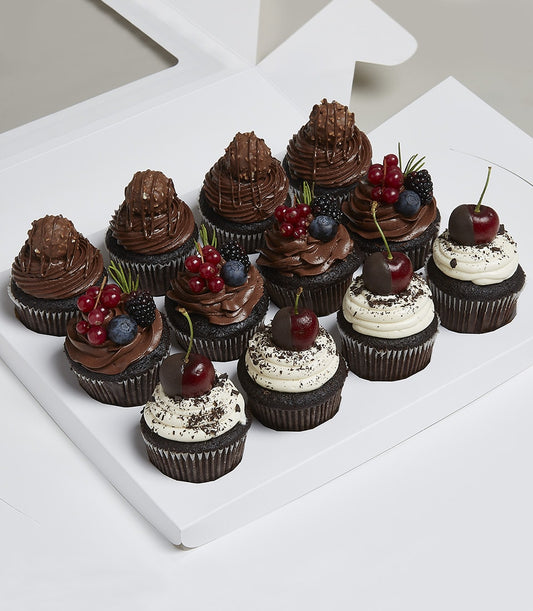 Charlotte Bakery artisan cupcakes in a box. British-style dark chocolate buttercream frosting, topped with fresh berries and chocolate-dipped cherries. Order custom cake Bangkok.