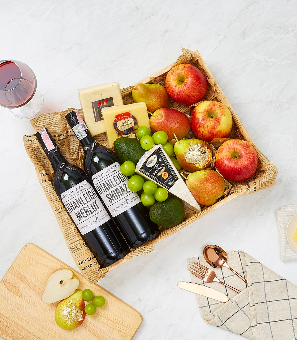 Premium South African wine and cheese gift basket with red wines, artisan cheeses, and fresh fruit