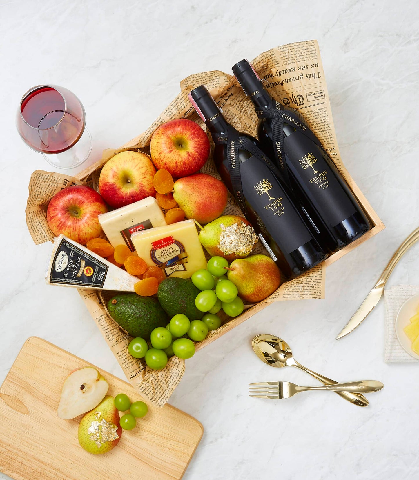 Luxury double red wine and cheese hamper with Merlot, Shiraz, Brie, cheddar, fresh fruit, and gold-leaf pear