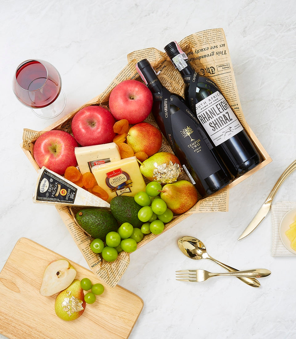 Premium wine and cheese gourmet hamper with Merlot, Shiraz, artisan cheeses, fresh fruit, and gold-leaf pear