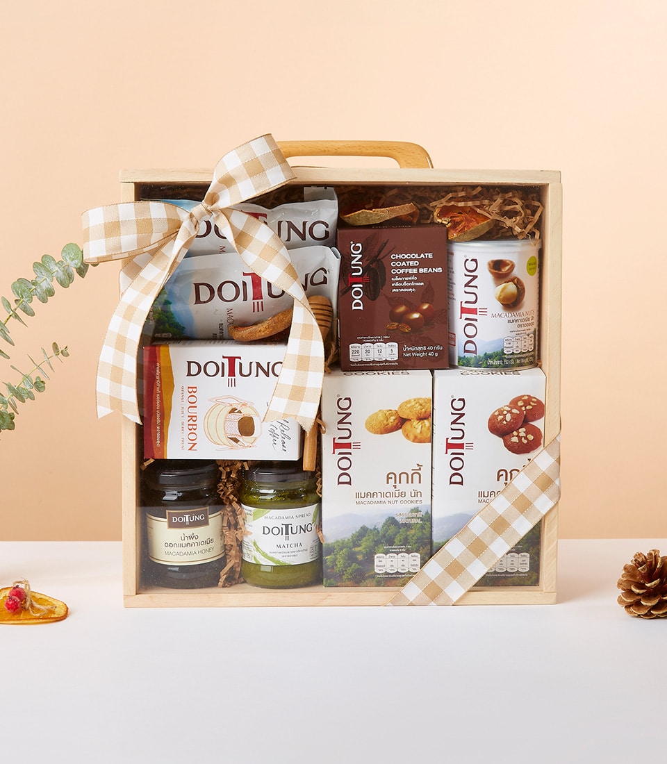 Light wood gift box with Doi Tung gourmet selection — chocolate coffee beans, macadamia nuts, cookies, and honey spreads
