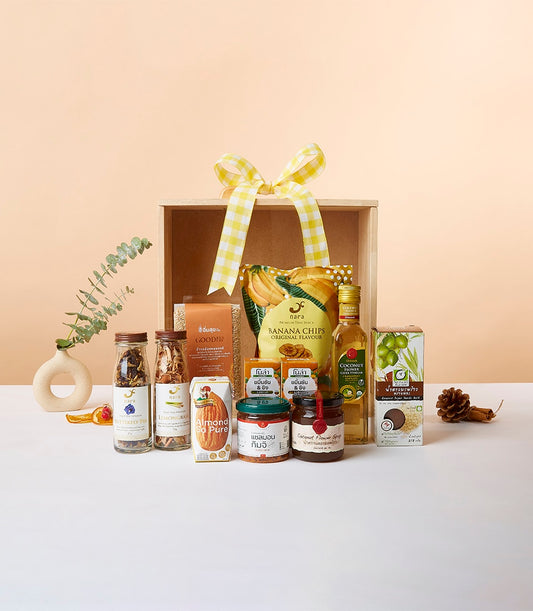 Premium healthful gift box with banana chips, butterfly pea, lemongrass, almond milk, and coconut syrup in wooden crate