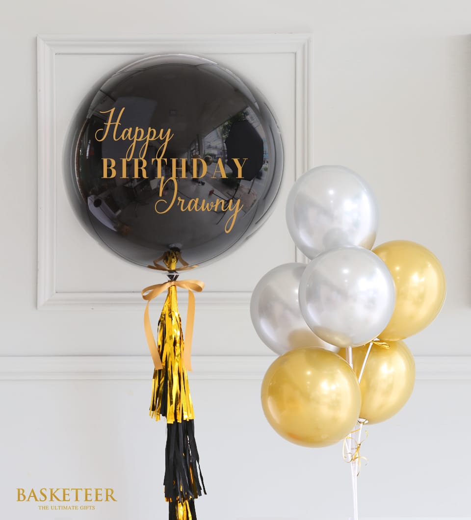 Black and gold Happy Birthday balloon set with metallic tassel garland and silver accent balloons
