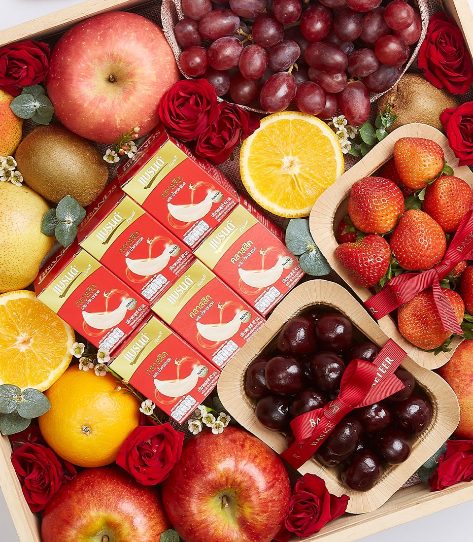 Fresh fruit gift box with apples, pears, kiwis, grapes, strawberries, cherries, bird's nest health drink packages, and red