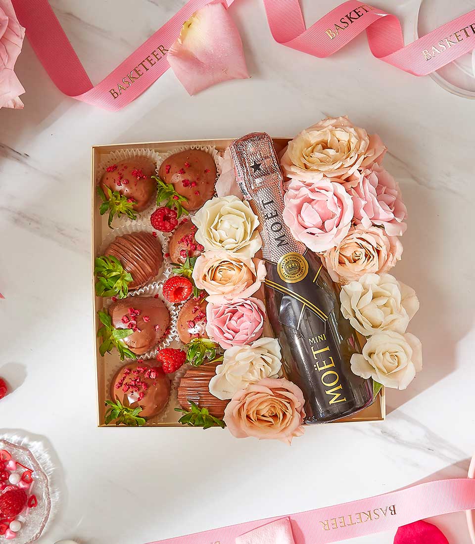 Luxury Valentine wine gift box with Moët champagne, chocolate-covered strawberries, and cream rose arrangement