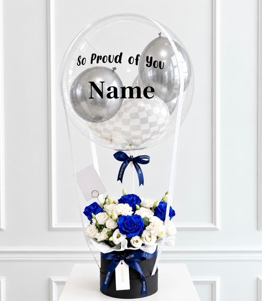 Basketeer luxury gift box with vibrant blue roses and white flowers, crowned by