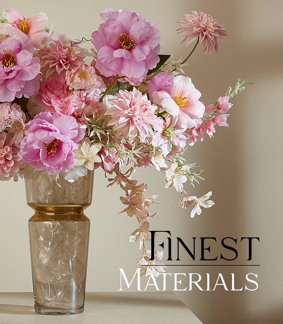 Tall glass vase with gold band filled with pink peonies, dahlias, and cream artificial flowers in premium arrangement