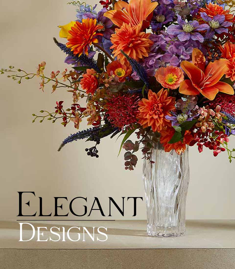 Vibrant artificial flower arrangement in ribbed glass vase with orange lilies, dahlias, and purple blooms for modern gifting