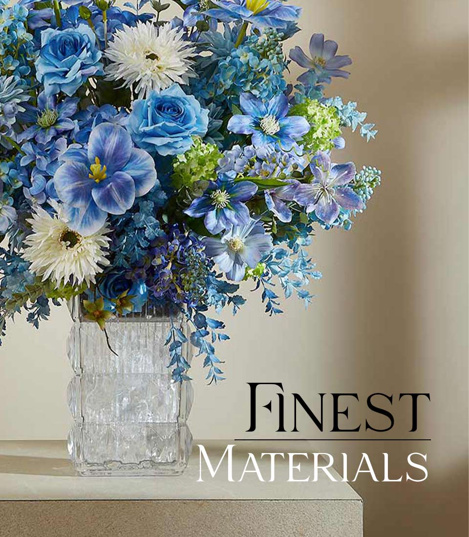 Graceful Serenity artificial flower vase with blue roses, white daisies, and green foliage in textured glass