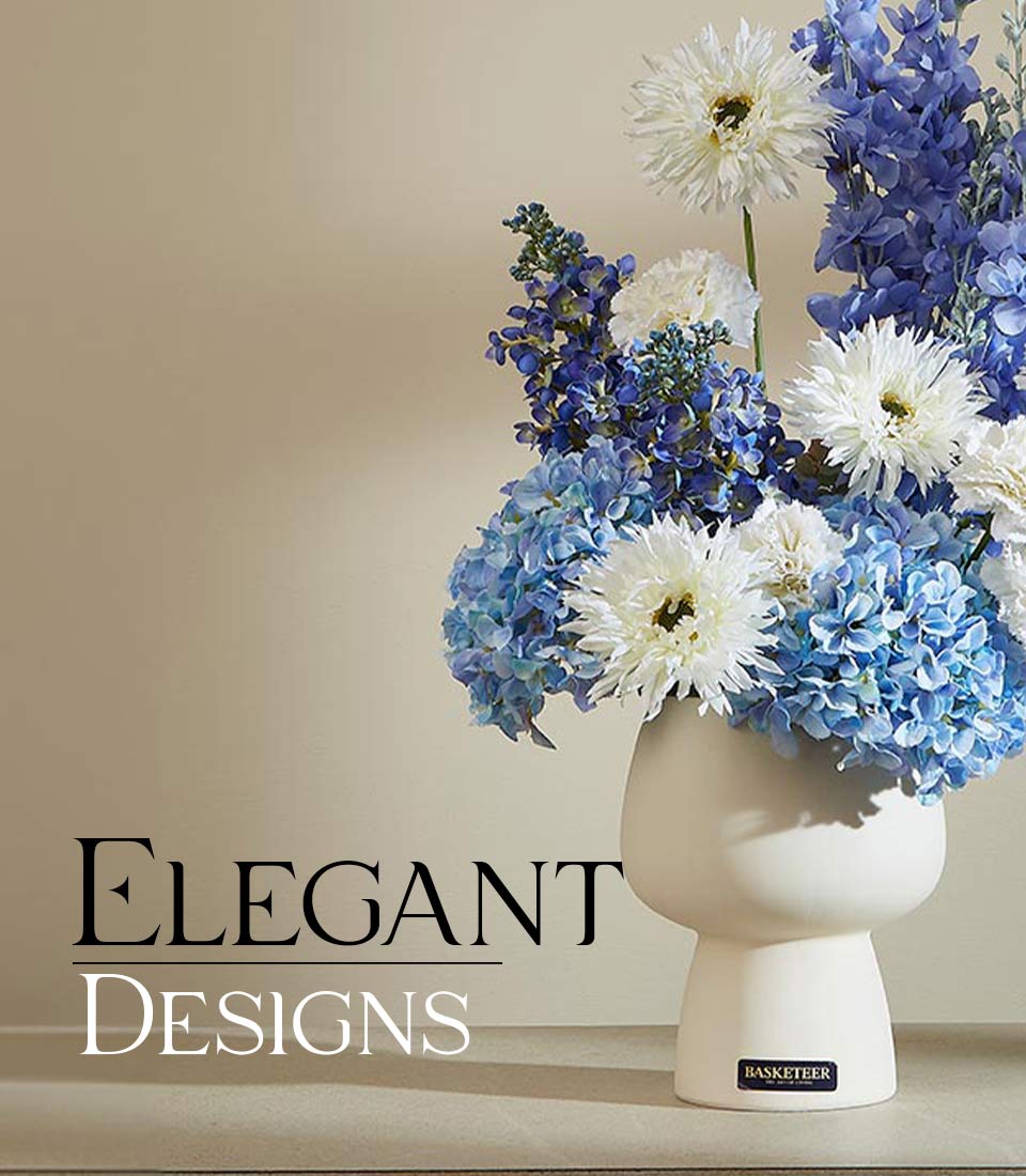Contemporary white vase with blue hydrangeas, delphiniums, and white chrysanthemums in lush arrangement