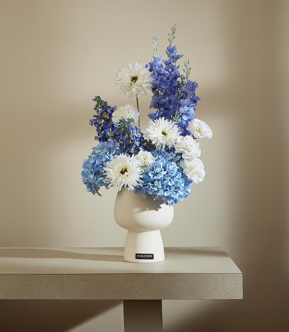 Elegant white ceramic vase with blue hydrangeas, delphiniums, and white dahlias artificial flower arrangement