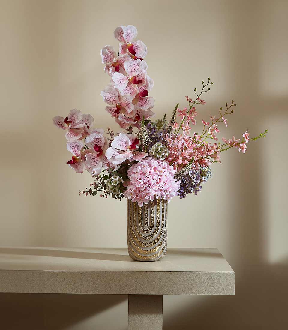 Spring Bliss artificial flower arrangement with pink hydrangeas, orchids and greenery in textured gold vase