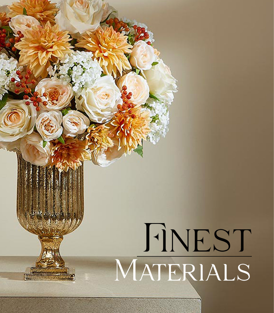 Luxe cream and peach rose arrangement in gold speckled urn vase with berry accents