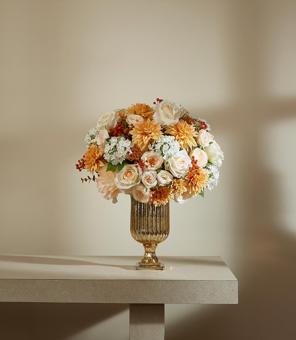 Warm Breeze Whispers artificial flower arrangement with peach roses and dahlias in textured gold urn vase