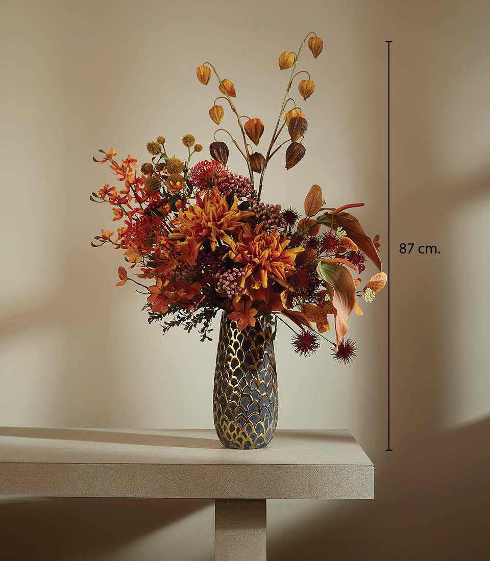 Autumn floral arrangement in dark patterned vase with orange dahlias, red blooms, and Chinese lanterns, 87cm tall