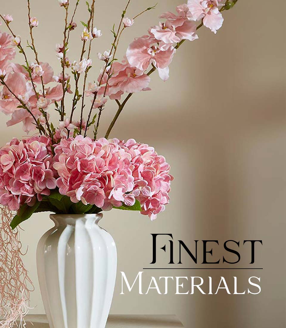 Pink hydrangea and orchid artificial flower arrangement in white ceramic vase