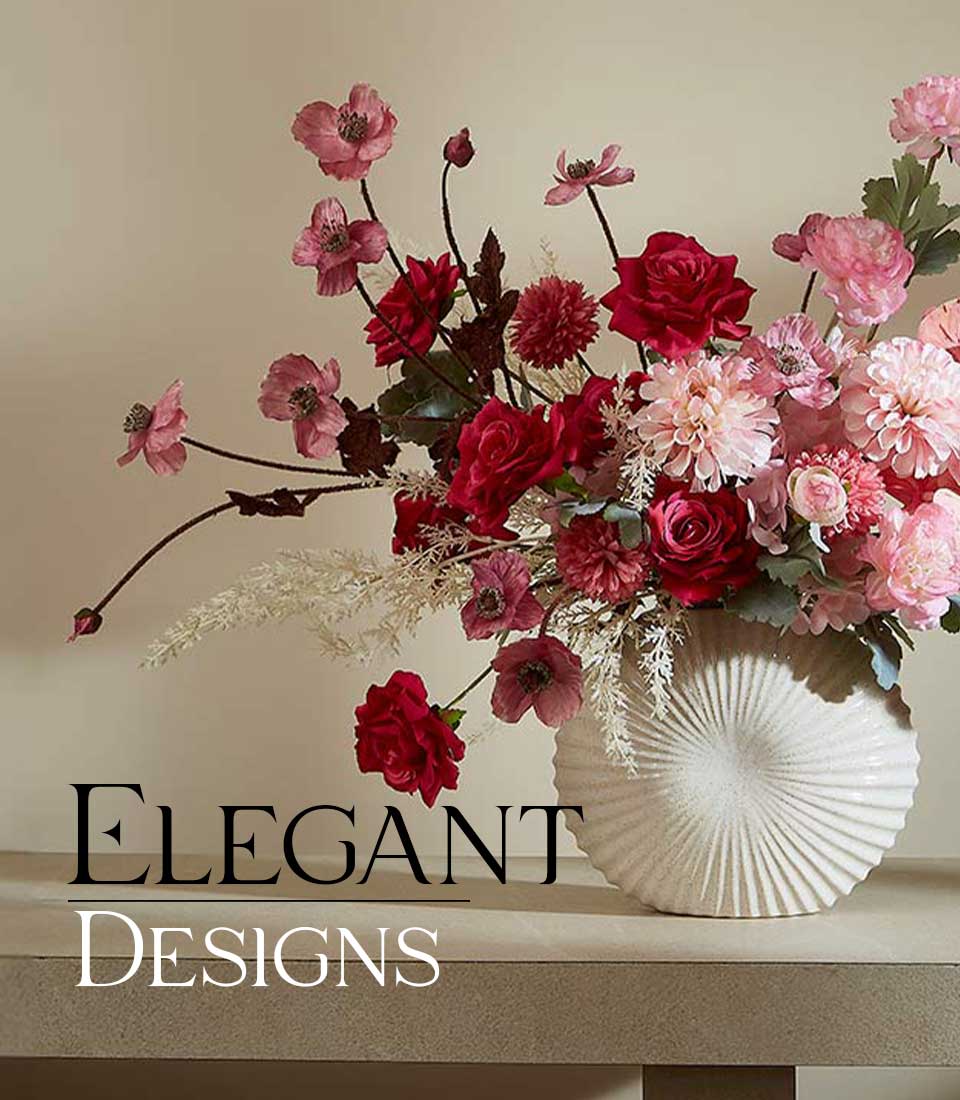 Romantic Charm artificial flower vase with deep red and pink roses, dahlias, and poppies in cream ceramic ribbed vase