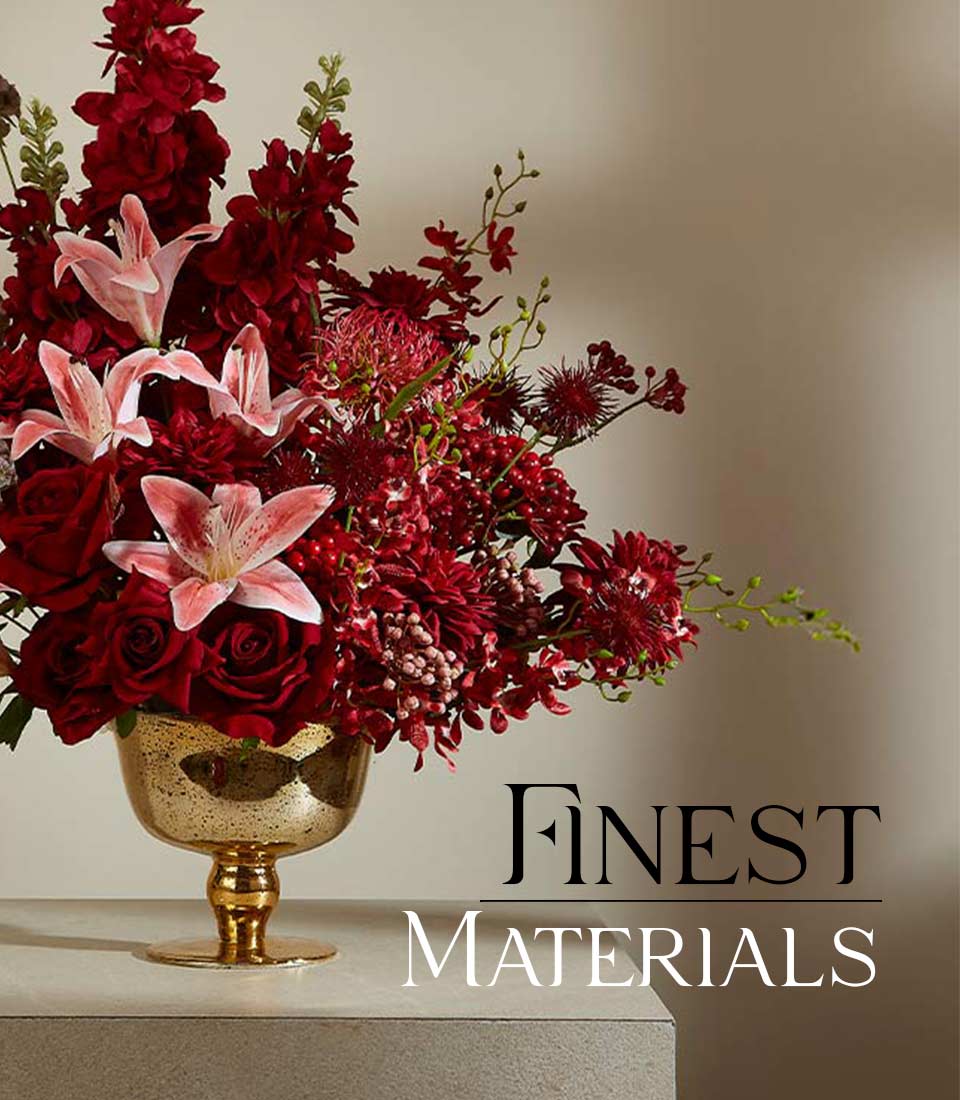 Crimson and pink luxury floral arrangement in antiqued gold goblet vase with roses, lilies, and berries
