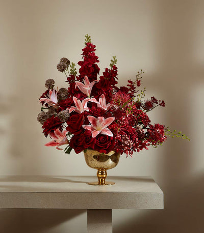 Crimson and burgundy rose arrangement with pink lilies in gold textured vase, luxury home décor gift
