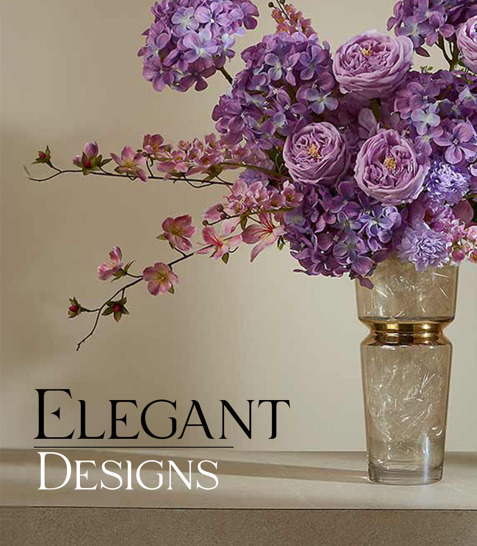 Purple roses and hydrangeas with pink accents in gold-banded glass vase, artisan artificial flower arrangement