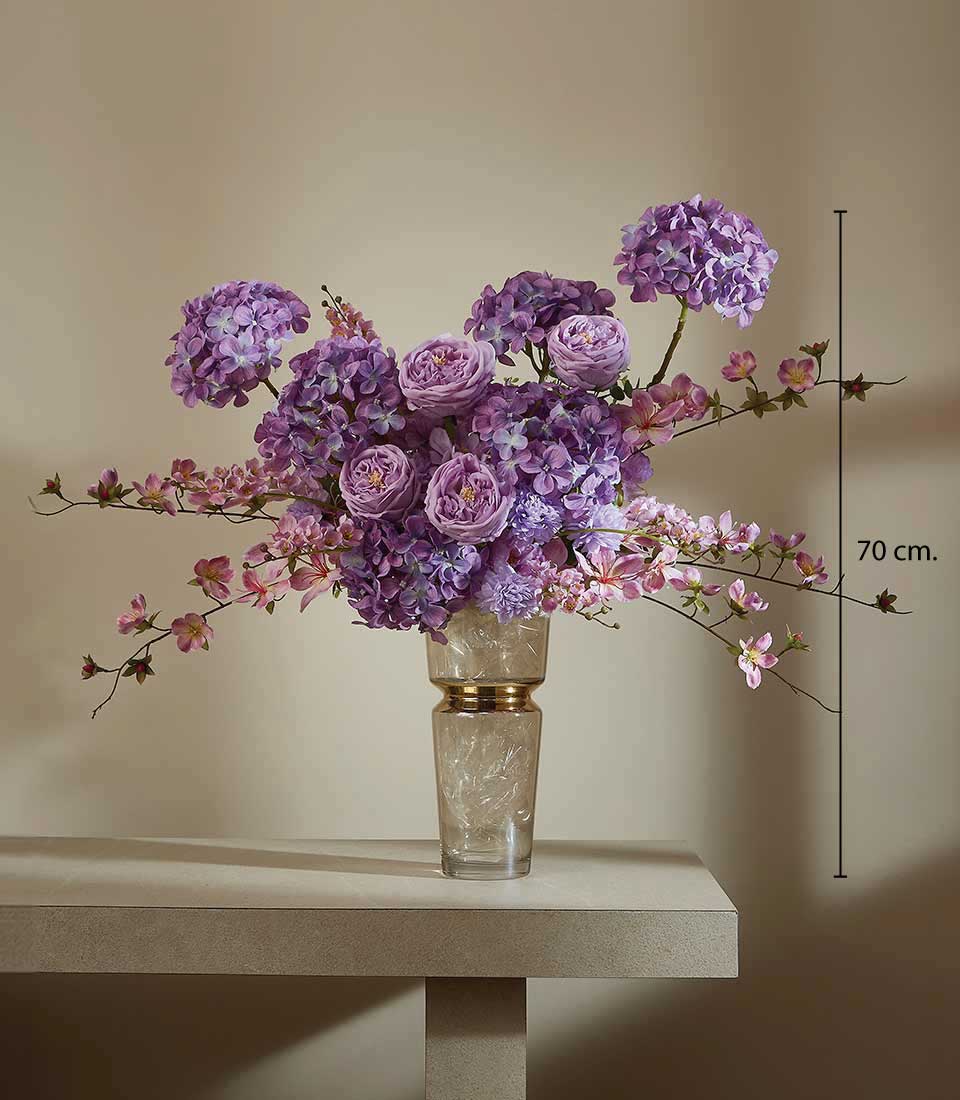 Purple and pink artificial flower arrangement in gold-accented glass vase, 70 cm tall