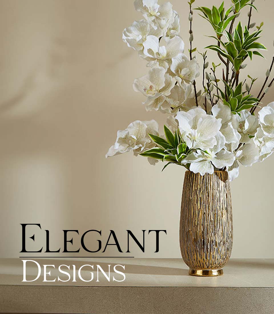Tall golden ribbed vase with white orchid arrangement and green foliage, elegant luxury gift