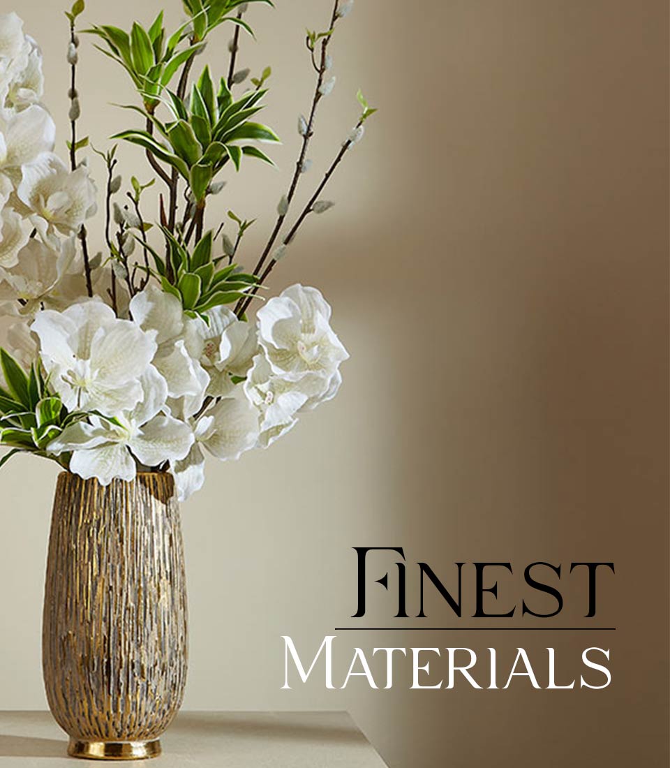Tall gold textured vase with white orchids, green foliage and catkin branches
