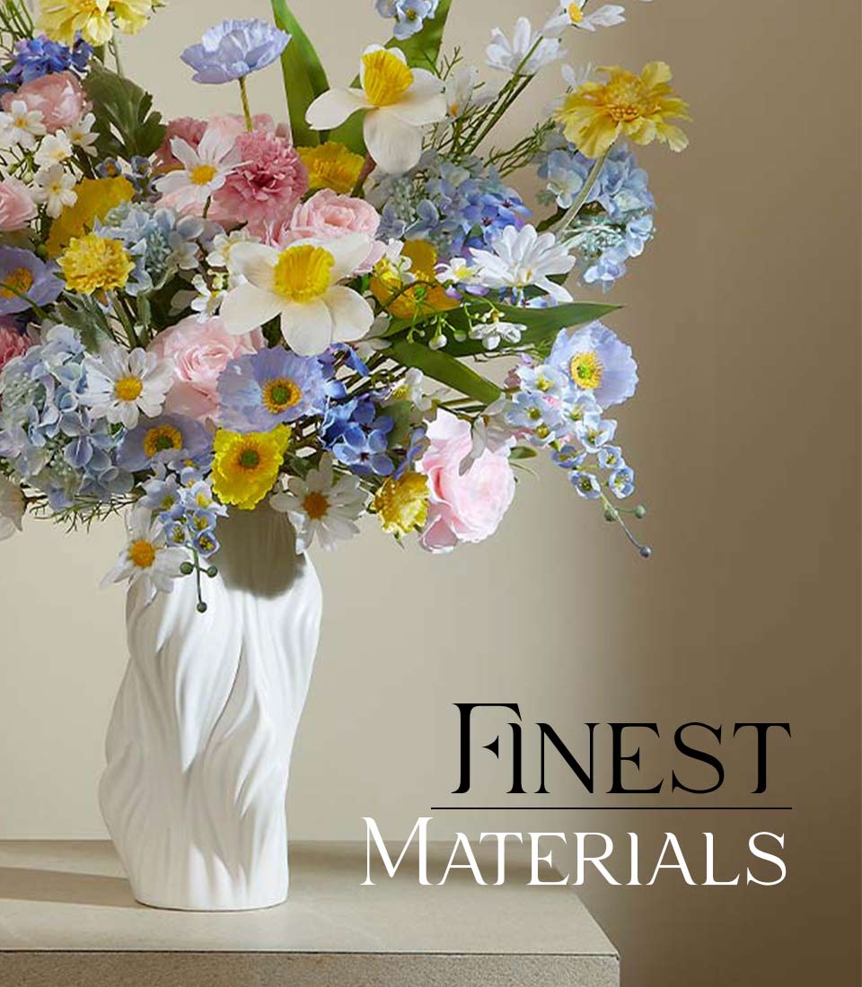 Vibrant spring bloom artificial flower arrangement in white ceramic vase with pink roses, blue hydrangeas, and yellow