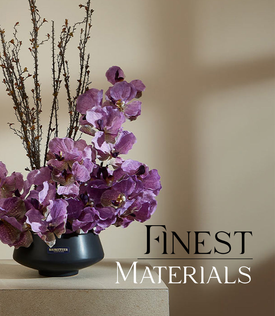Vibrant purple orchids with textured branches in matte black ceramic vase, premium artificial flower arrangement for elegant