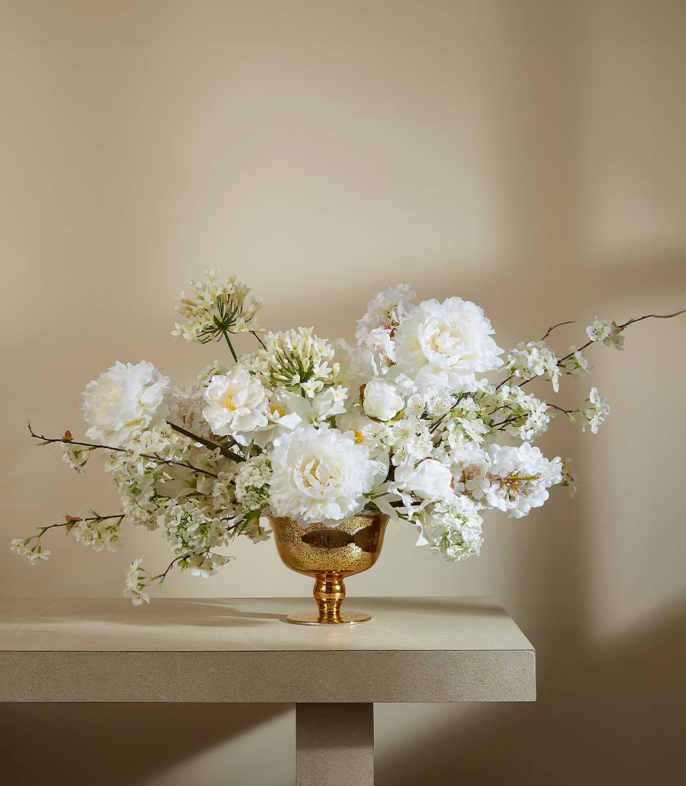 Luxurious white peony and allium arrangement in hammered gold footed bowl, elegant gift centerpiece