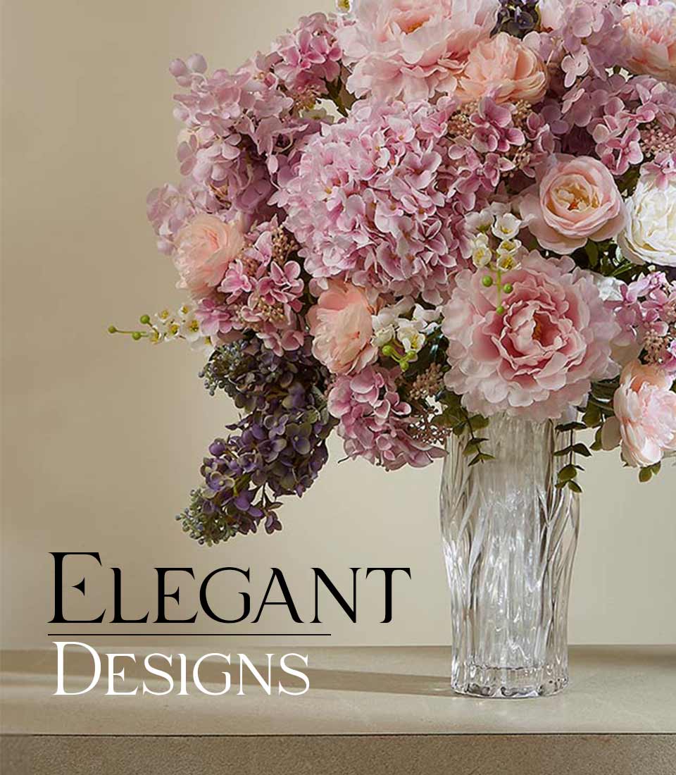 Elegant artificial flower arrangement with pink peonies, hydrangeas, and white blooms in textured glass vase