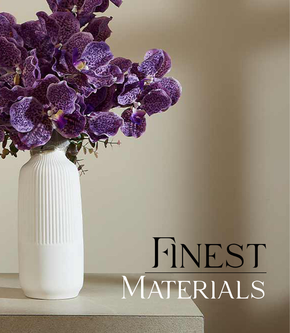 White ribbed ceramic vase with vibrant purple speckled orchids, modern luxury gift arrangement