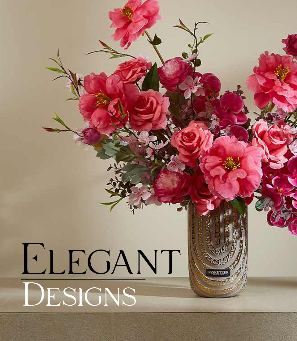 Contemporary chic artificial flower arrangement in gold and cream patterned vase with pink peonies and roses