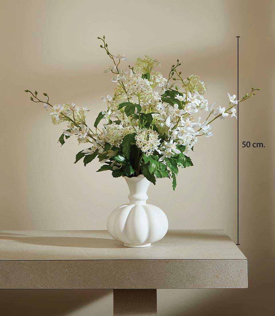 White artificial flower arrangement with orchids and greenery in fluted ceramic vase, 50cm tall