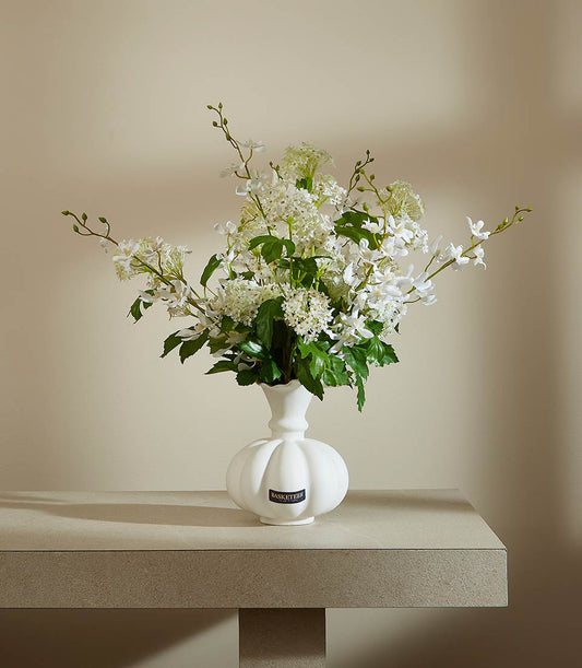 White ceramic pumpkin vase with orchids and hydrangea-style blooms, artificial flower arrangement for elegant home décor
