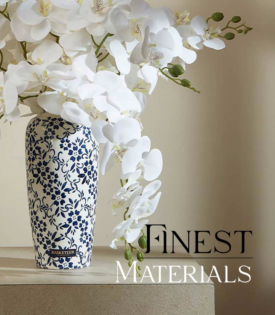 White orchid artificial flower arrangement in blue patterned cylindrical vase for elegant home decor