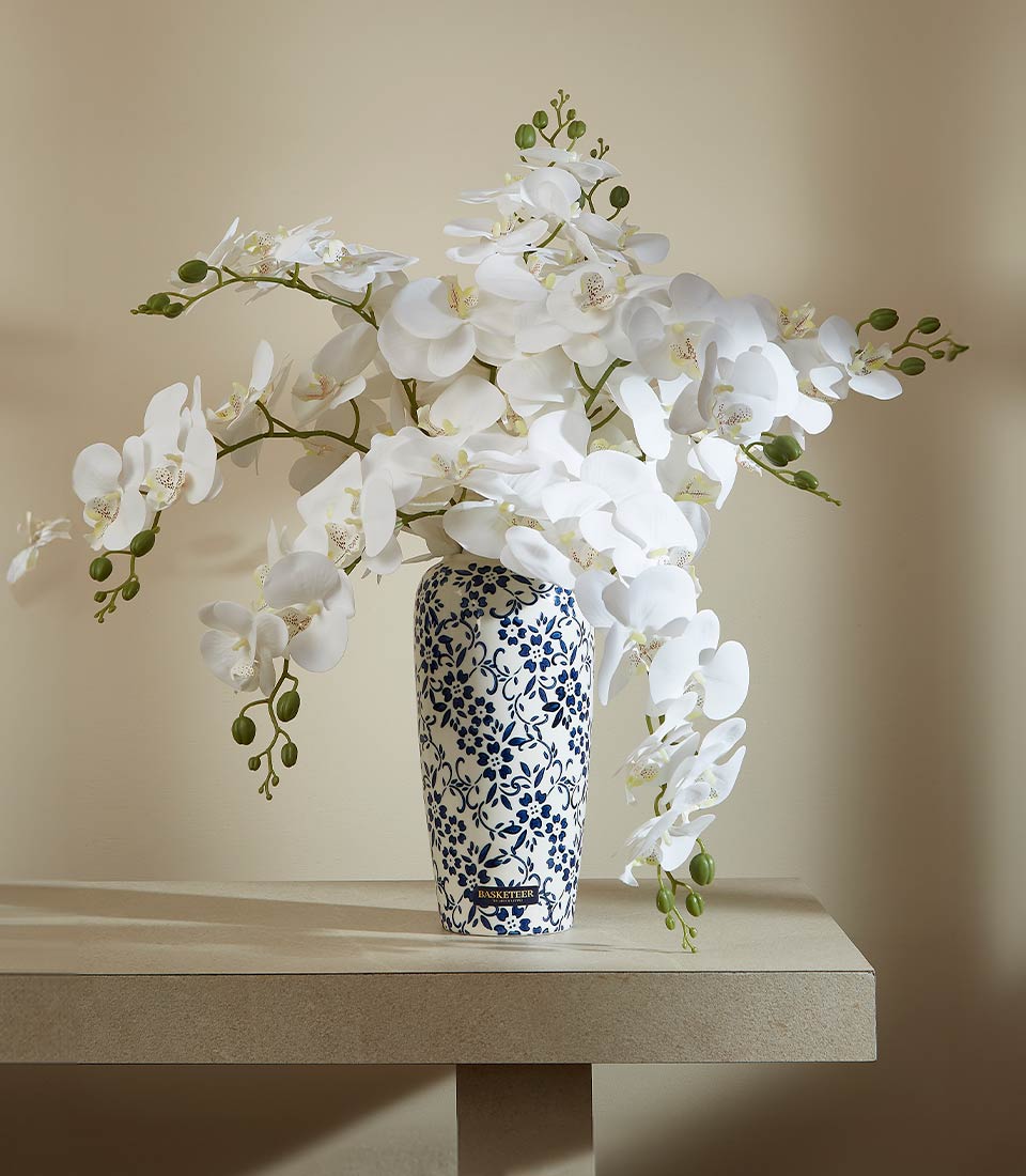 White orchid artificial flower arrangement in blue-patterned vase, luxury gift