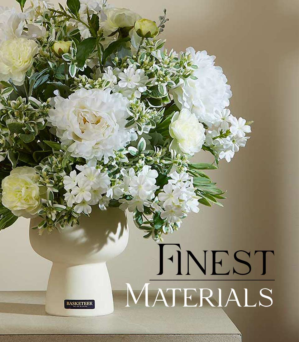 Cream vase with white peonies, yellow blooms, and green-white foliage in elegant artificial flower arrangement
