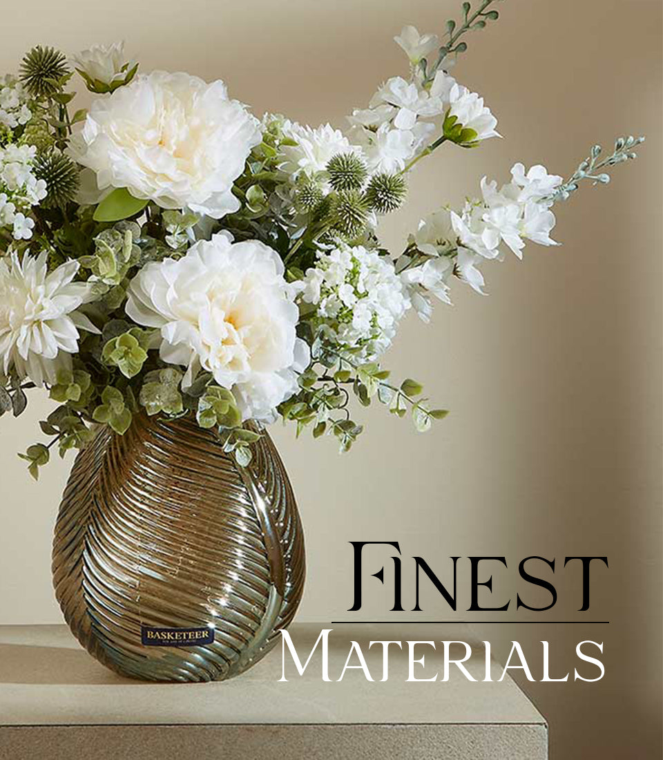 Lush white peony and dahlia artificial flower arrangement in bronze ribbed glass vase with green foliage accents