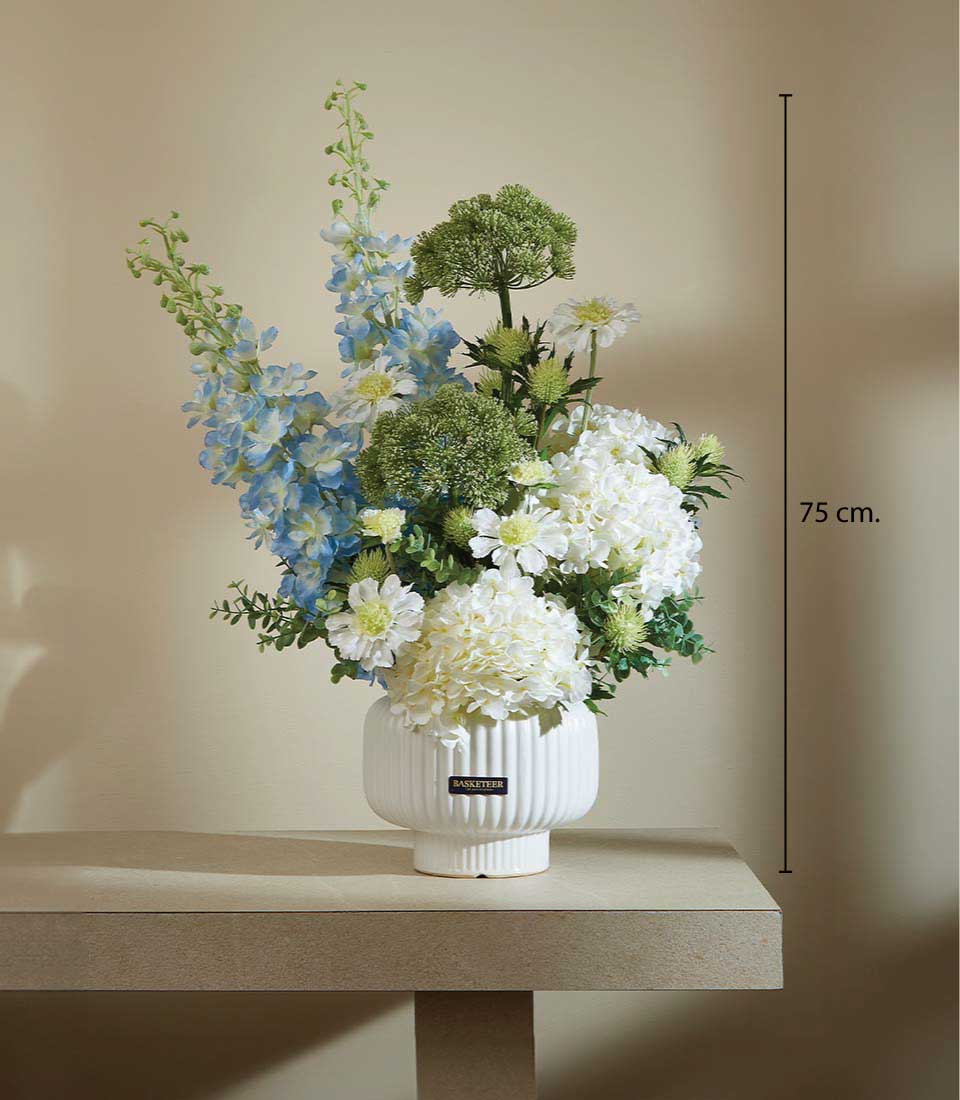 Soothing Harmony artificial flower arrangement with blue delphiniums, white hydrangeas, and green thistles in ribbed white