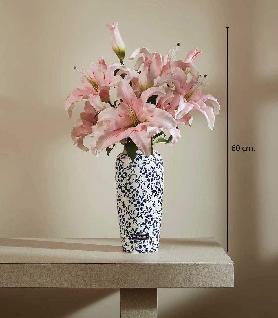 Tall white ceramic vase with blue floral pattern holding vibrant pink artificial lilies arrangement, 60 cm height