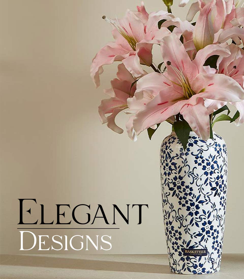 Pink lily artificial flowers in white ceramic vase with blue vine pattern